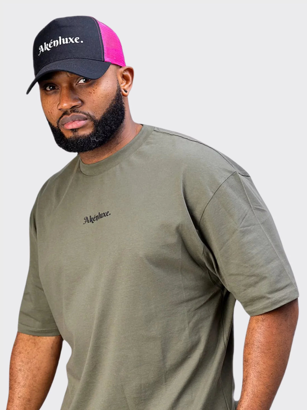 ide angle of the AkénLuxe Oversized Logo T-Shirt, emphasizing its structured fit and breathable cotton material.